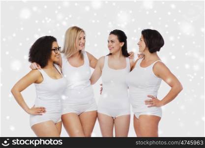 friendship, beauty, body positive and people concept - group of happy women different in white underwear over snow