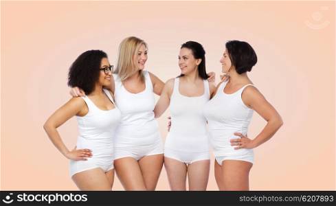 friendship, beauty, body positive and people concept - group of happy women different in white underwear over beige background