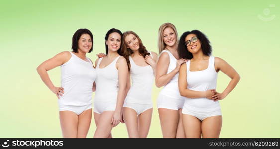 friendship, beauty, body positive and people concept - group of happy women different in white underwear over green natural background