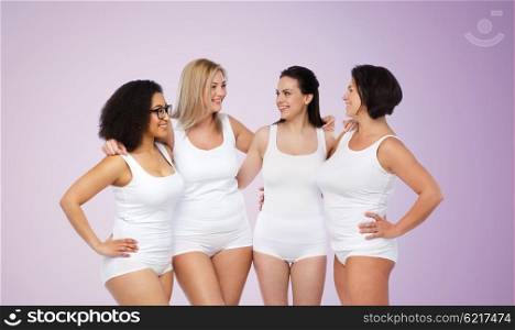 friendship, beauty, body positive and people concept - group of happy women different in white underwear over violet background