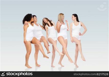 friendship, beauty, body positive and people concept - group of happy women different in white underwear over gray background