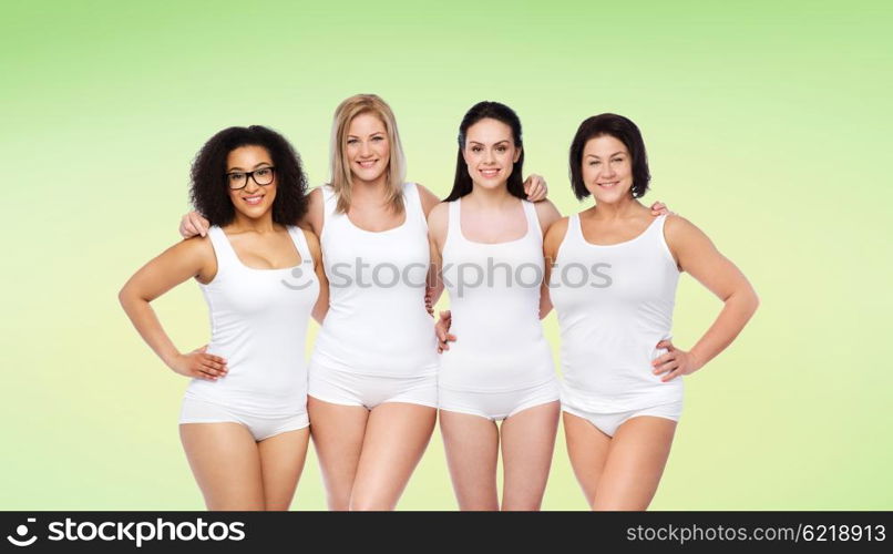 friendship, beauty, body positive and people concept - group of happy women different in white underwear over green natural background