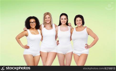 friendship, beauty, body positive and people concept - group of happy women different in white underwear over green natural background