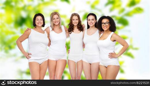 friendship, beauty, body positive and people concept - group of happy women different in white underwear over green natural summer background