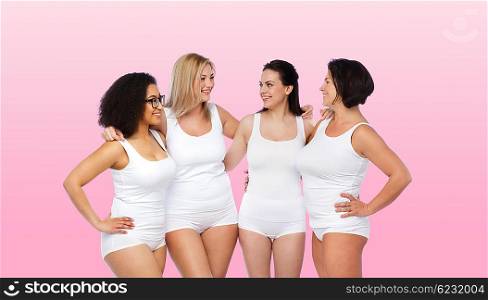 friendship, beauty, body positive and people concept - group of happy women different in white underwear over pink background