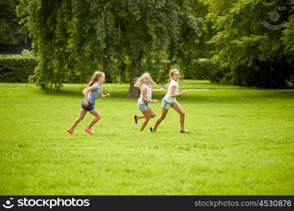 friendship, childhood, leisure and people concept - group of happy kids or friends playing catch-up game and running in summer park