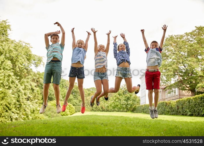 friendship, childhood, leisure and people concept - group of happy kids or friends jumping up and having fun in summer park