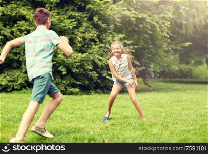 friendship, childhood, leisure and people concept - group of happy kids or friends playing catch-up game and running in summer park. happy kids running and playing game outdoors