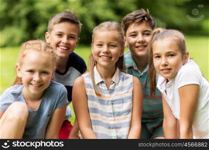 friendship, childhood, leisure and people concept - group of happy kids or friends in summer park
