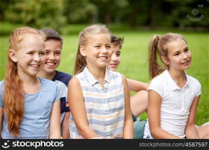 friendship, childhood, leisure and people concept - group of happy kids or friends in summer park