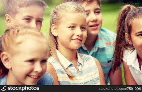 friendship, childhood, leisure and people concept - group of happy kids or friends in summer park. group of happy kids or friends outdoors