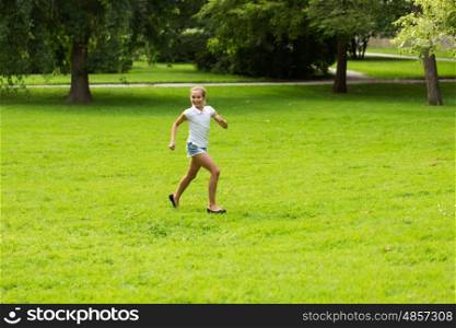 friendship, childhood, leisure and people concept - happy girl running and playing in summer park. happy girl running and playing at summer outdoors