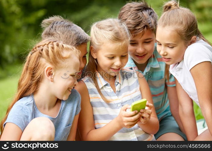 friendship, childhood, technology and people concept - group of happy kids or friends with smartphone in summer park