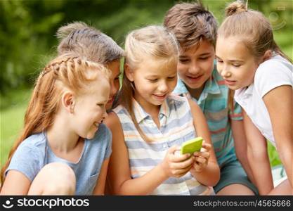 friendship, childhood, technology and people concept - group of happy kids or friends with smartphone in summer park
