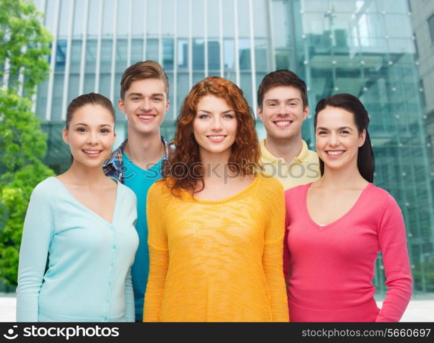 friendship, city life, business and people concept - group of smiling teenagers over city background