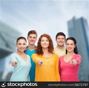 friendship, city life, business and people concept - group of smiling teenagers over city background