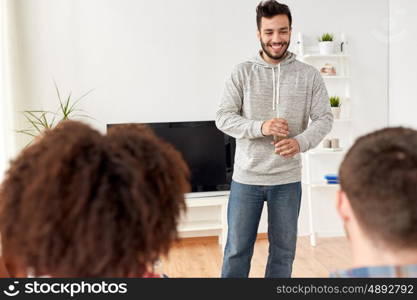 friendship, communication and people concept - group of happy friends talking at home