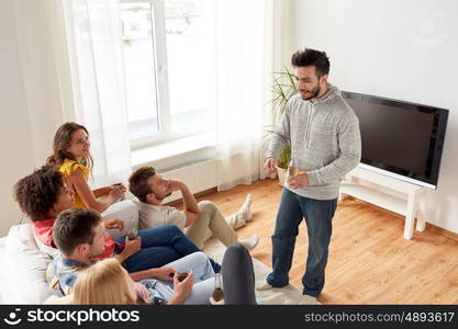 friendship, communication and people concept - group of happy friends talking at home