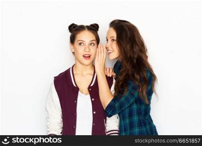 friendship, communication and people concept - happy teenage girls gossiping or sharing secrets over white background. teenage girls gossiping or sharing secrets