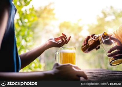 Friendship Concept. Two Friends Drinking Beer and Talking about some Topic at the Balcony in Summer