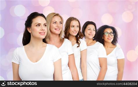 friendship, diverse, body positive and people concept - group of happy different size women in white t-shirts over rose quartz and serenity holidays lights background