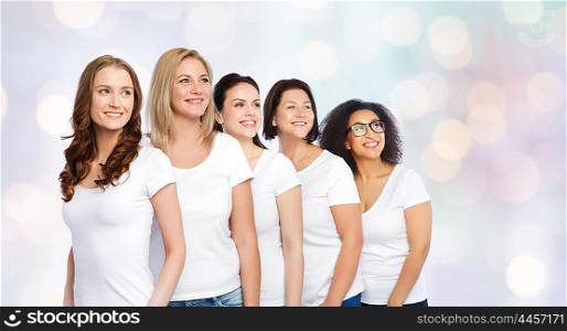 friendship, diverse, body positive and people concept - group of happy different size women in white t-shirts over holidays lights background