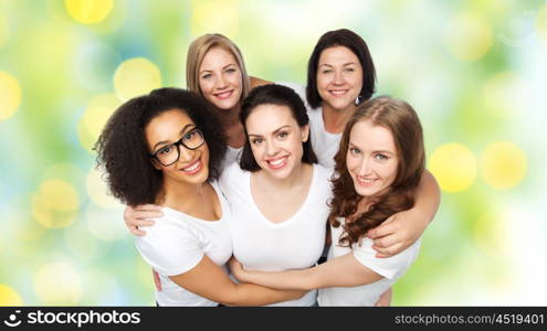 friendship, diverse, body positive and people concept - group of happy different size women in white t-shirts over green holidays lights background