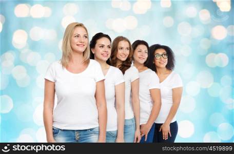 friendship, diverse, body positive and people concept - group of happy different size women in white t-shirts over blue holidays lights background