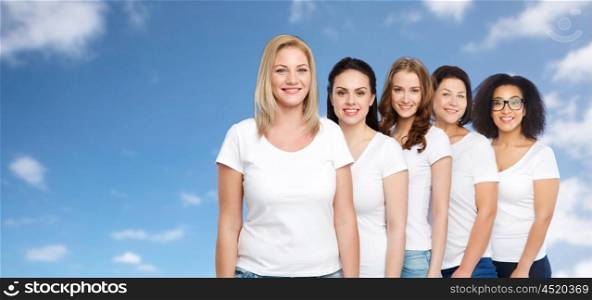 friendship, diverse, body positive and people concept - group of happy different size women in white t-shirts over blue sky and clouds background