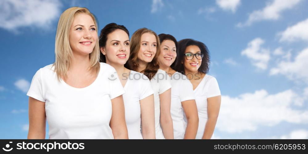 friendship, diverse, body positive and people concept - group of happy different size women in white t-shirts over blue sky and clouds background