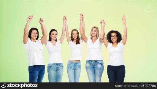 friendship, diverse, body positive and people concept - group of happy different size women in white t-shirts holding hands up over green natural background