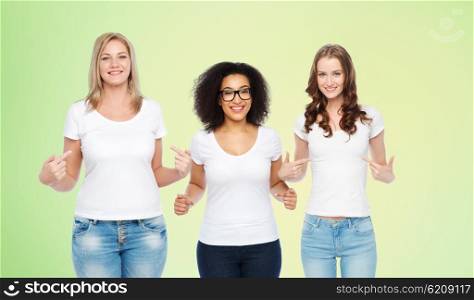friendship, diverse, body positive and people concept - group of happy different size women in white t-shirts pointing finger to themselves over green natural background