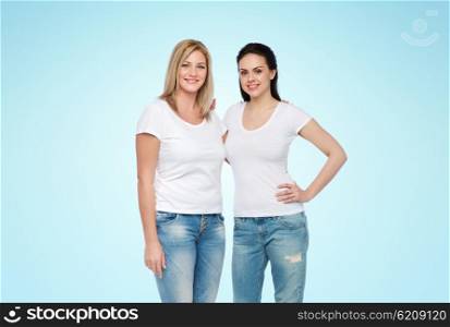 friendship, diverse, body positive and people concept - group of happy different women in white t-shirts hugging over blue background