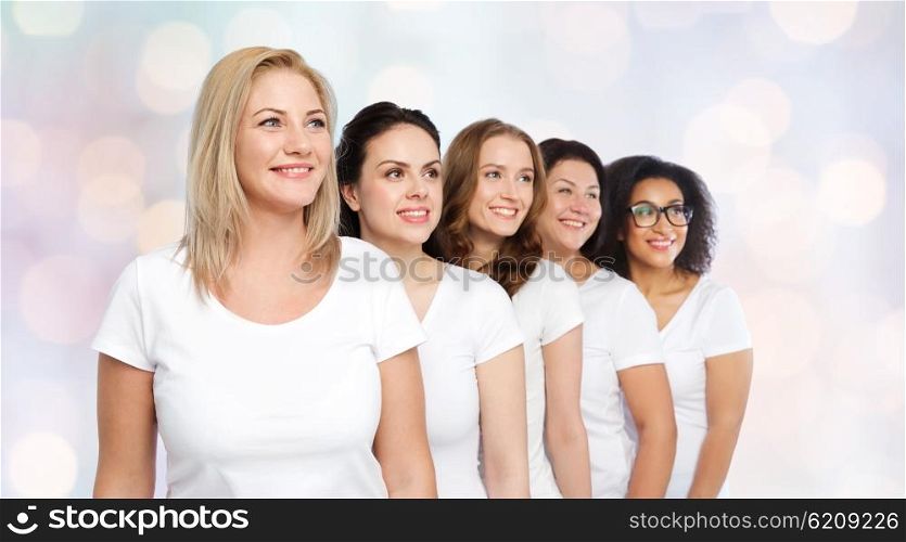 friendship, diverse, body positive and people concept - group of happy different size women in white t-shirts over holidays lights background
