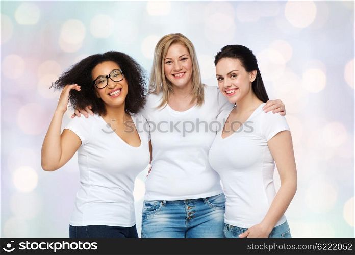 friendship, diverse, body positive and people concept - group of happy different size women in white t-shirts hugging over holidays lights background