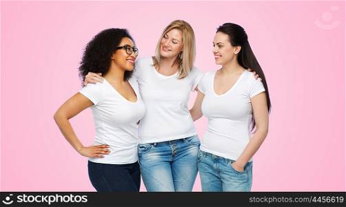 friendship, diverse, body positive, communication and people concept - group of happy different size women in white t-shirts hugging and talking over pink background