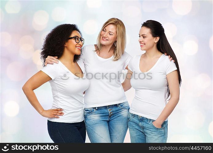 friendship, diverse, body positive, communication and people concept - group of happy different size women in white t-shirts hugging and talking over holidays lights background