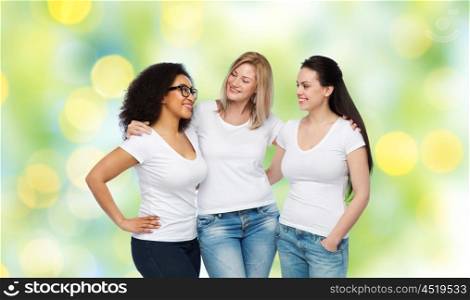 friendship, diverse, body positive, communication and people concept - group of happy different size women in white t-shirts hugging and talking over green holidays lights background