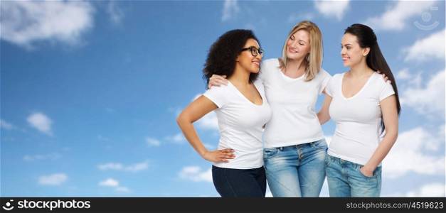 friendship, diverse, body positive, communication and people concept - group of happy different size women in white t-shirts hugging and talking over blue sky and clouds background