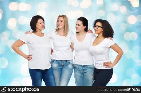 friendship, diverse, body positive, communication and people concept - group of happy different size women in white t-shirts hugging and talking over blue holidays lights background