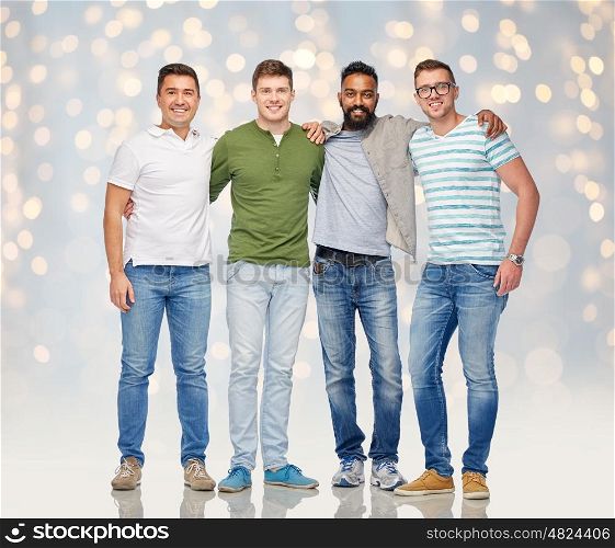 friendship, diversity, ethnicity and people concept - international group of happy smiling men over holidays lights background