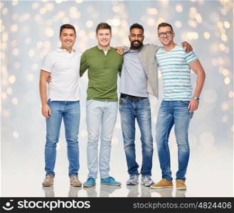 friendship, diversity, ethnicity and people concept - international group of happy smiling men over holidays lights background