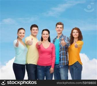 friendship, dream, future and people concept - group of smiling teenagers showing thumbs up over blue sky with white cloud background