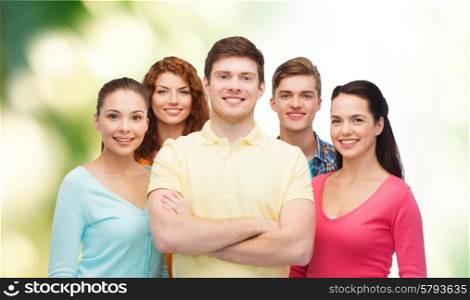 friendship, ecology and people concept - group of smiling teenagers standing over green background
