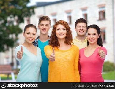 friendship, education, summer vacation and people concept - group of smiling teenagers showing thumbs up over campus background