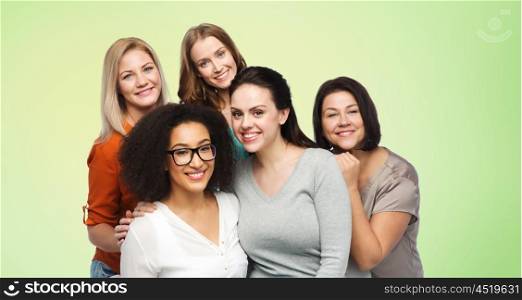 friendship, fashion, body positive, diverse and people concept - group of happy different women in casual clothes over green natural background