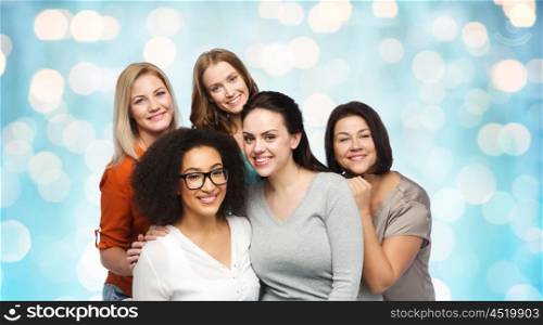 friendship, fashion, body positive, diverse and people concept - group of happy different women in casual clothes over blue holidays lights background