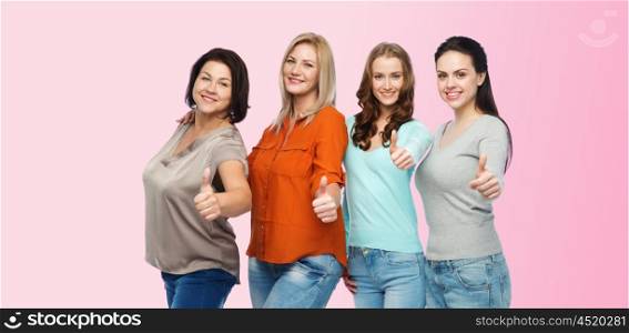 friendship, fashion, body positive, gesture and people concept - group of happy different size women in casual clothes showing thumbs up over pink background