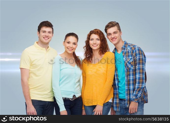 friendship, future and people concept - group of smiling teenagers standing over gray background with laser light