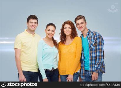 friendship, future and people concept - group of smiling teenagers standing over gray background with laser light